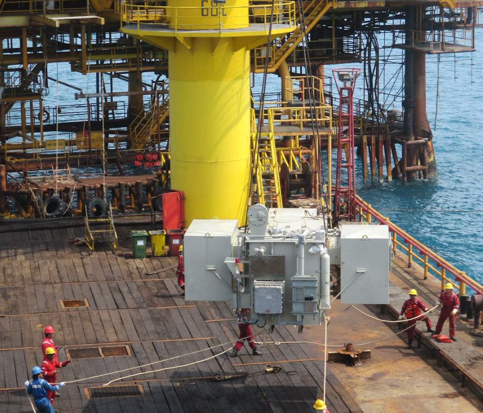 Offshore lifting application with workers using taglines to guide a suspended equipment load